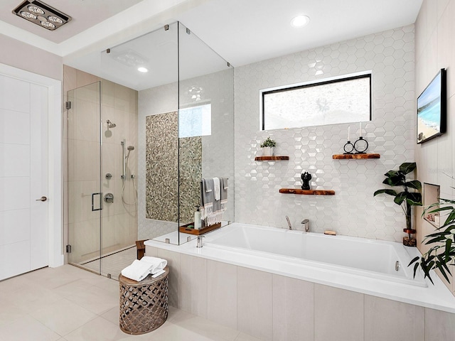 bathroom featuring separate shower and tub and tile patterned flooring