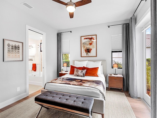 bedroom featuring ensuite bath, light hardwood / wood-style floors, and ceiling fan