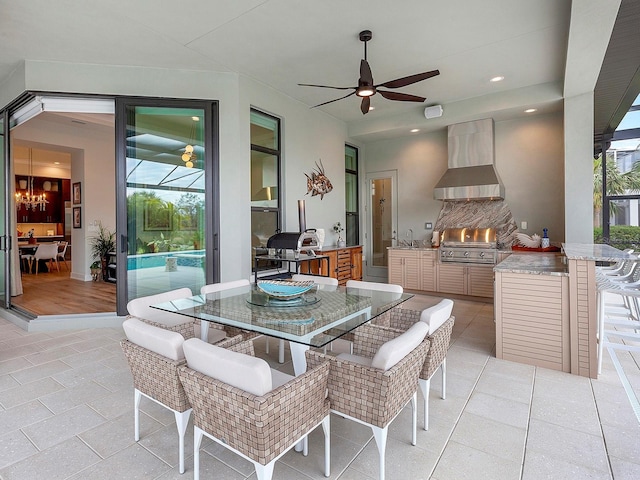 dining space featuring sink, ceiling fan with notable chandelier, and light tile patterned floors