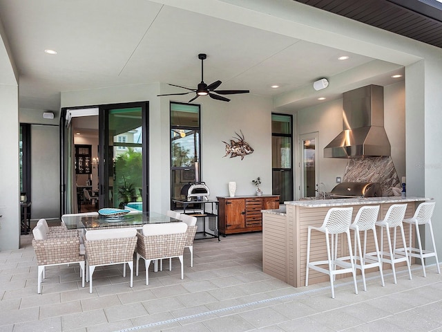 view of patio / terrace with a grill, an outdoor wet bar, and ceiling fan