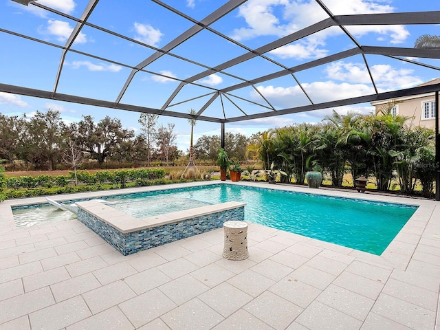 view of swimming pool with an in ground hot tub, a lanai, and a patio