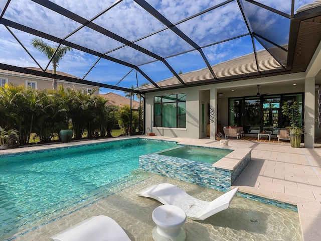 view of swimming pool featuring an in ground hot tub, ceiling fan, a patio, and glass enclosure