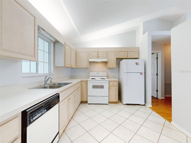 kitchen featuring sink, vaulted ceiling, white appliances, and light tile patterned floors