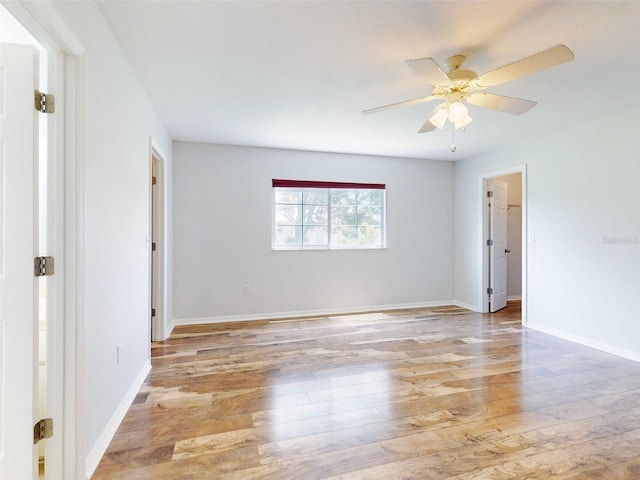 empty room with light wood-type flooring and ceiling fan