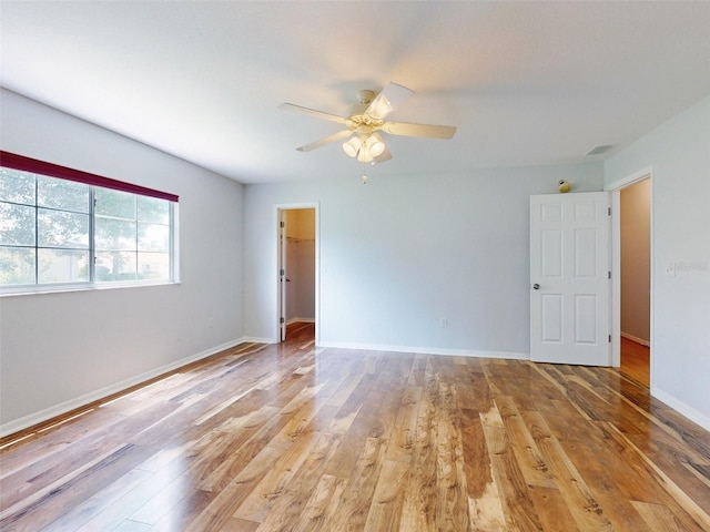 empty room featuring ceiling fan and light hardwood / wood-style flooring