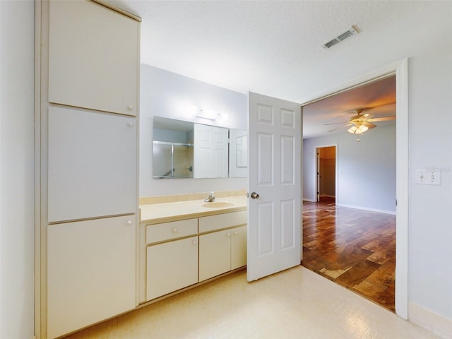 bathroom featuring a shower with door, vanity, ceiling fan, and hardwood / wood-style flooring