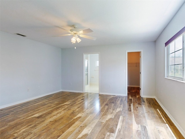 spare room with ceiling fan and light wood-type flooring