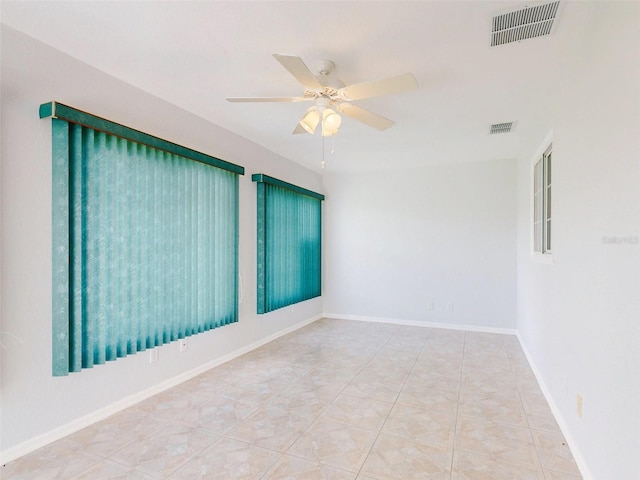 spare room featuring ceiling fan and tile patterned floors