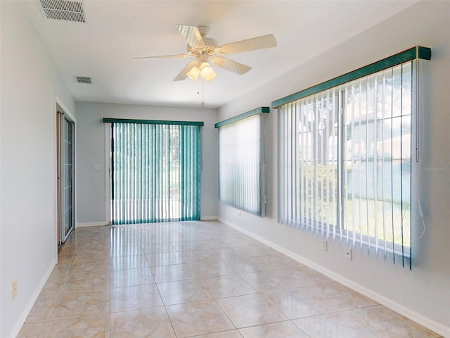 spare room featuring ceiling fan and light tile patterned flooring