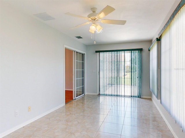 tiled spare room featuring ceiling fan