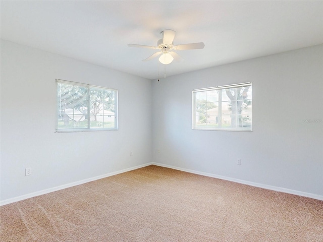 carpeted empty room featuring ceiling fan