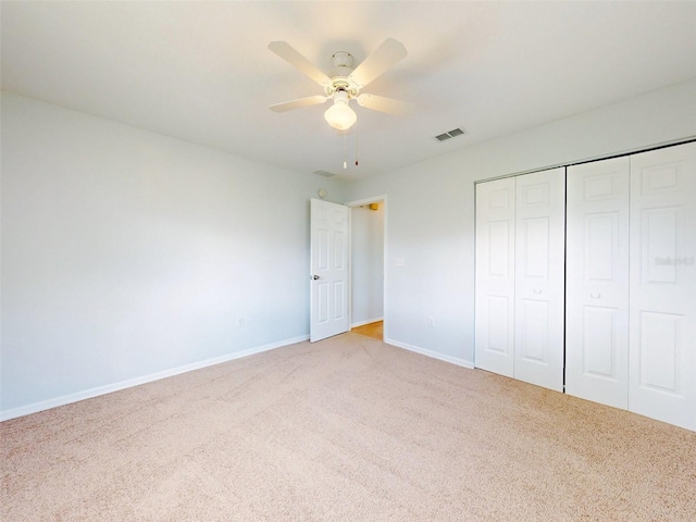 unfurnished bedroom with ceiling fan and light colored carpet