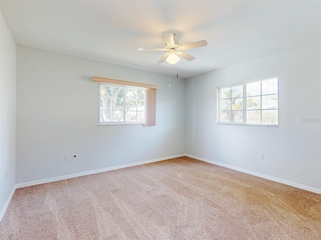 empty room featuring light carpet and ceiling fan