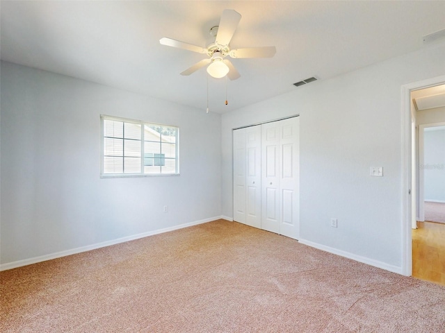 unfurnished bedroom featuring carpet flooring, a closet, and ceiling fan