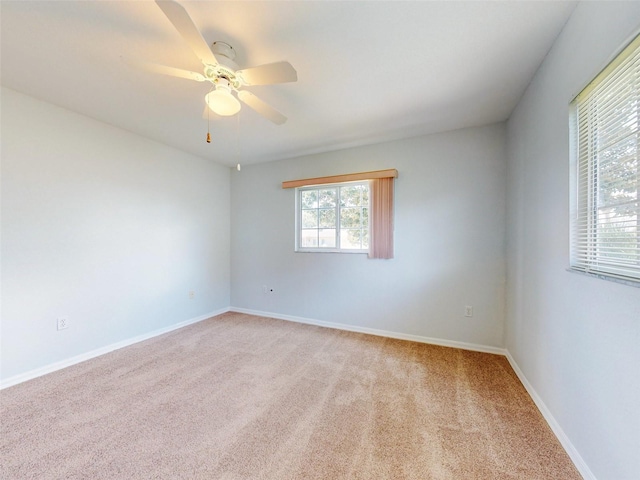 spare room featuring ceiling fan and light carpet