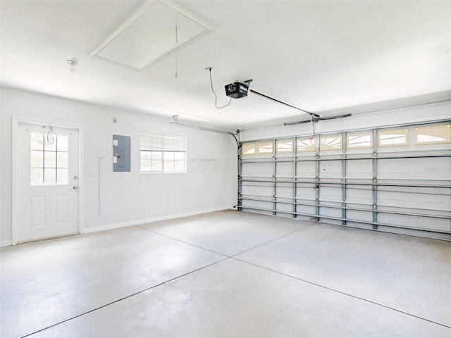 garage with electric panel and a garage door opener