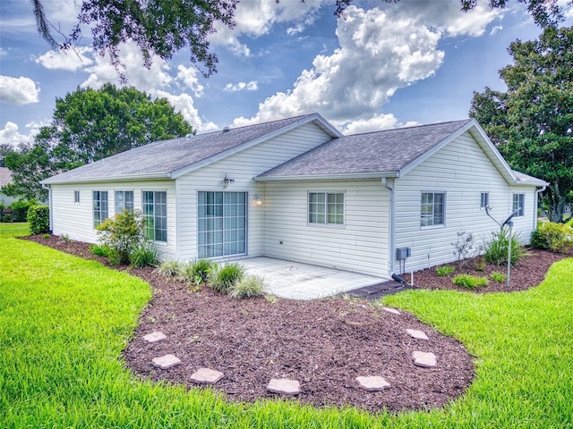 back of house featuring a patio and a yard