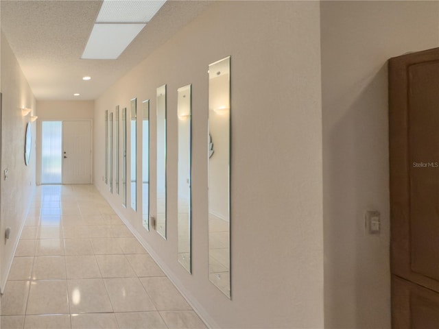 corridor featuring light tile patterned floors