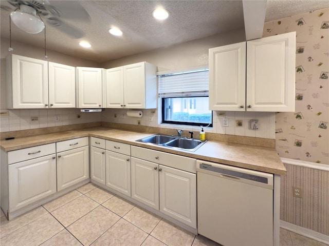 kitchen featuring dishwasher, sink, white cabinetry, and a textured ceiling