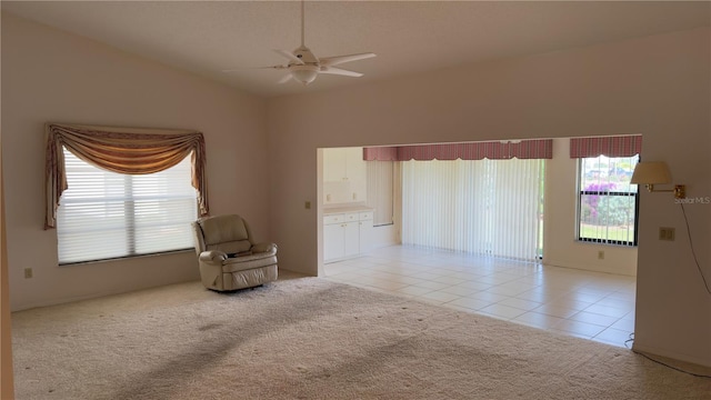 unfurnished room with ceiling fan, light tile patterned floors, and lofted ceiling