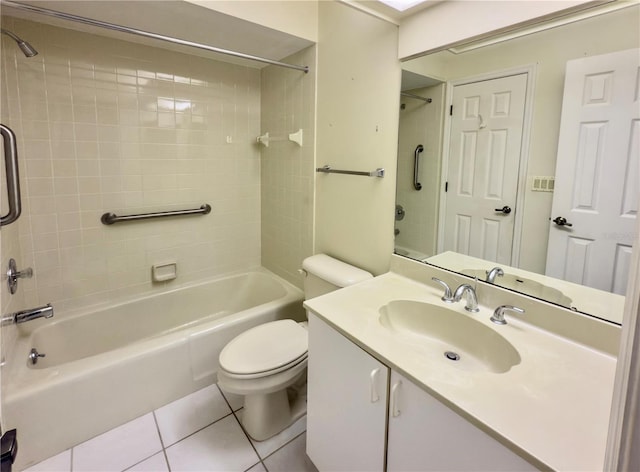 full bathroom featuring toilet, vanity, tiled shower / bath, and tile patterned flooring