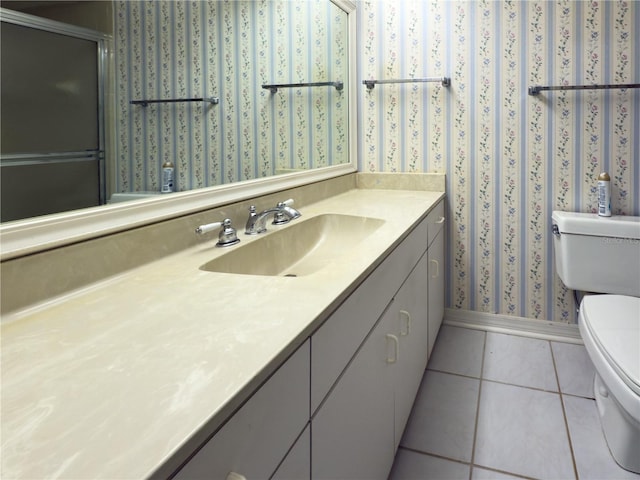 bathroom with toilet, tile patterned flooring, and vanity