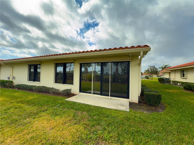 rear view of property with a patio area and a yard