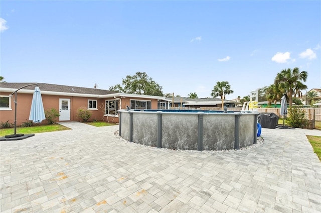 view of swimming pool featuring a patio area