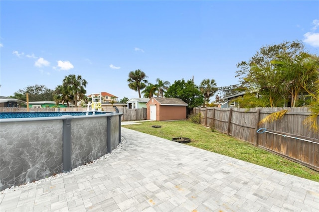 view of patio / terrace with a fenced in pool and a shed