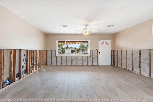 spare room with ceiling fan and light wood-type flooring