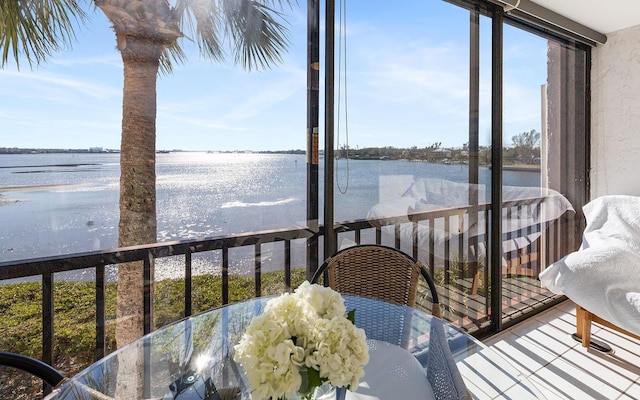 sunroom / solarium with a water view