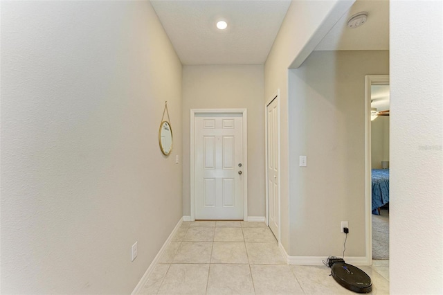 hall with light tile patterned floors