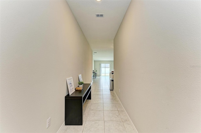 corridor featuring light tile patterned floors