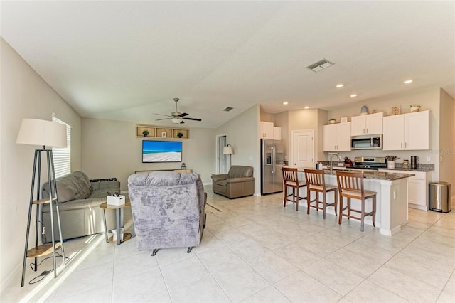 tiled living room with ceiling fan