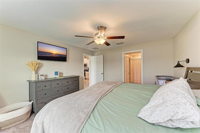 bedroom featuring ceiling fan, a textured ceiling, and carpet floors