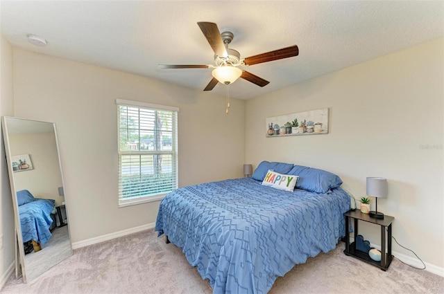 bedroom featuring ceiling fan and light carpet