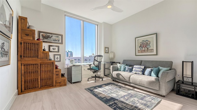 living room with ceiling fan and light hardwood / wood-style floors