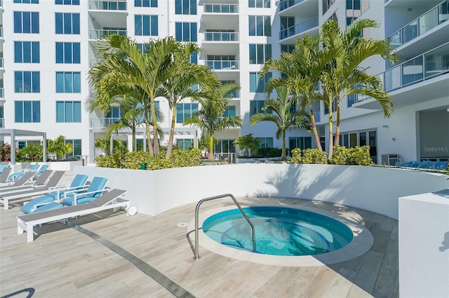 view of swimming pool featuring a community hot tub