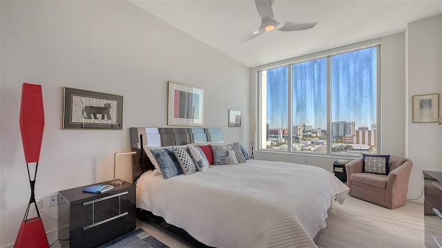 bedroom featuring ceiling fan, vaulted ceiling, and light hardwood / wood-style flooring