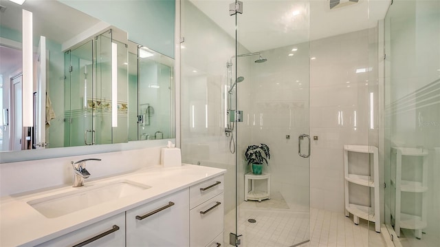 bathroom with vanity and a shower with shower door