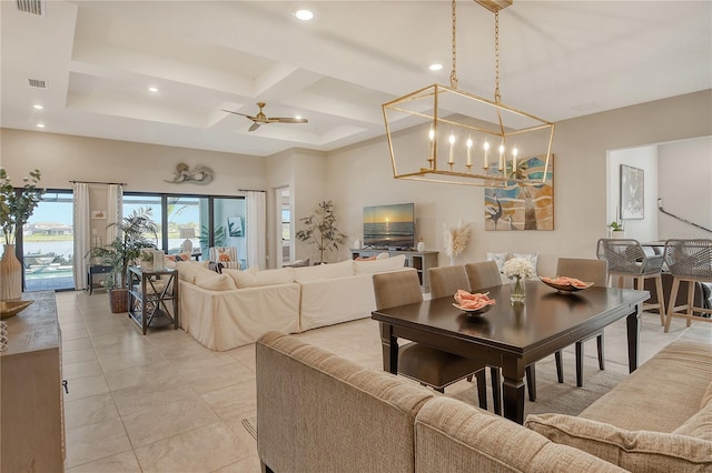 dining space featuring a towering ceiling, ceiling fan with notable chandelier, coffered ceiling, light tile patterned floors, and beam ceiling