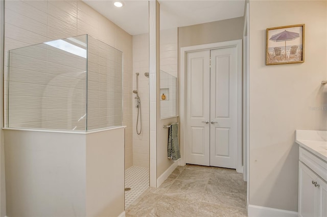 bathroom featuring vanity and a tile shower