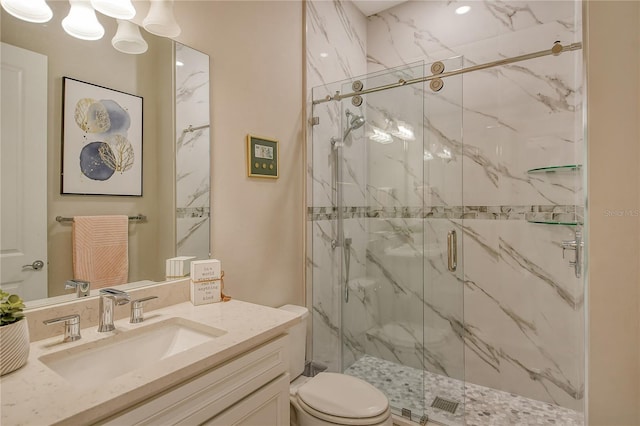 bathroom with vanity, an enclosed shower, and toilet