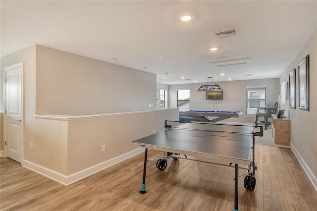 game room featuring light hardwood / wood-style flooring and a wealth of natural light