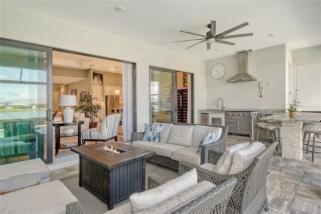 view of patio / terrace featuring an outdoor living space with a fire pit and ceiling fan