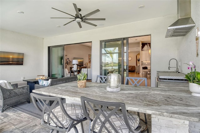 view of patio with ceiling fan and an outdoor bar