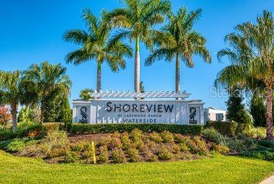 community sign featuring a lawn