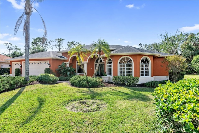 view of front of property with a front yard and a garage