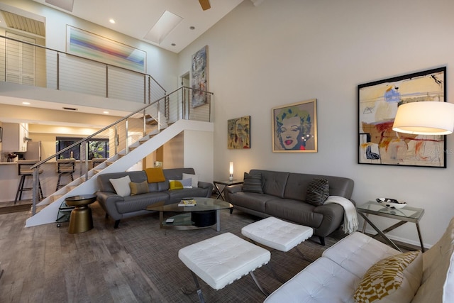 living room with hardwood / wood-style floors and high vaulted ceiling