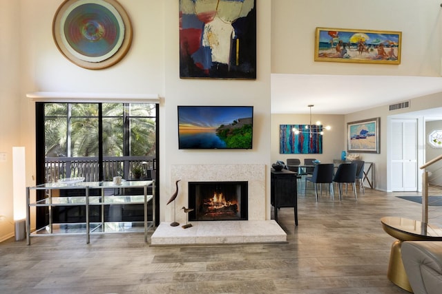 living room featuring an inviting chandelier and wood-type flooring